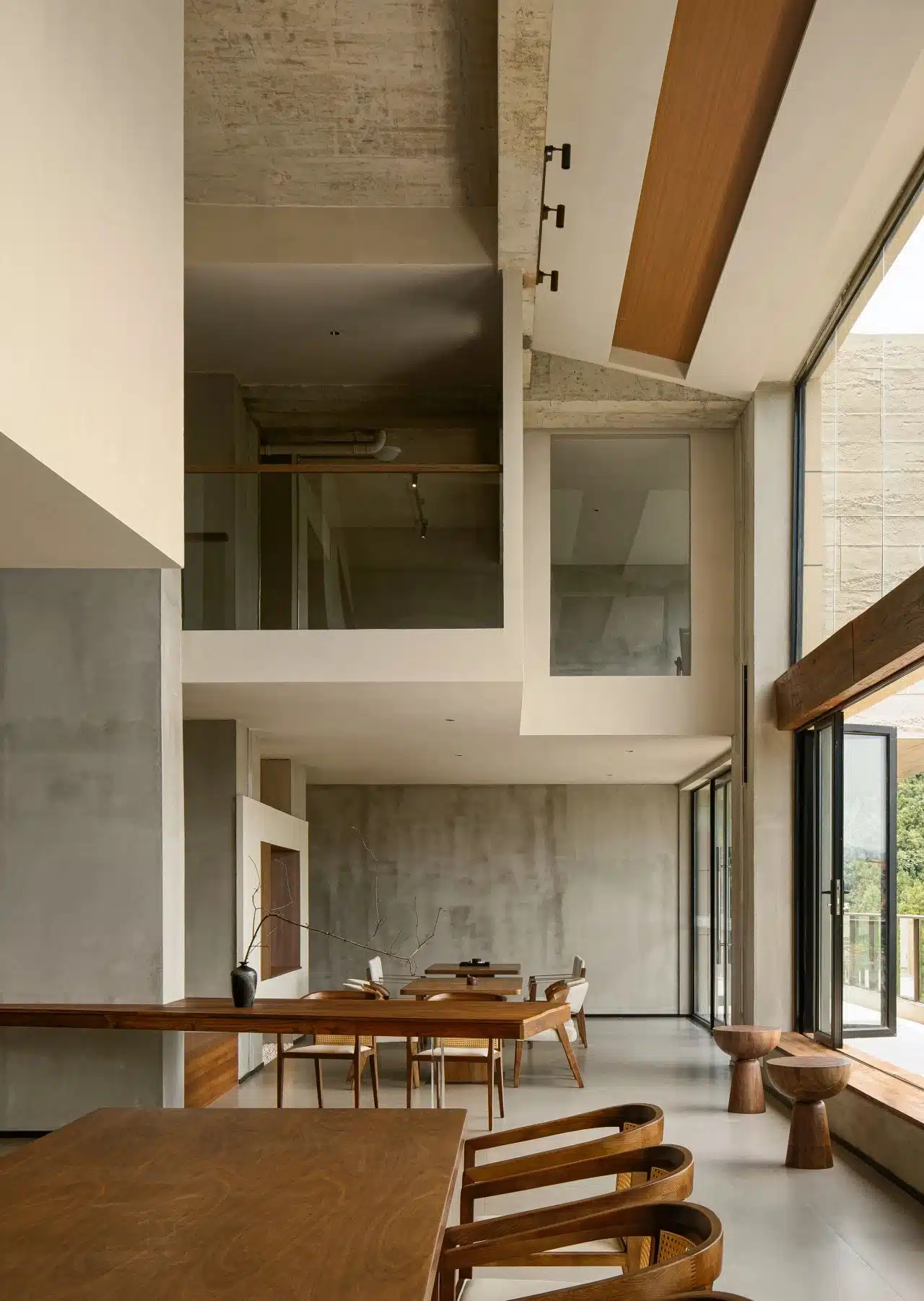 精緻工業風咖啡廳室內設計，保留水泥粉光地板與裸露管線，搭配細緻金屬陳列架展現個性。